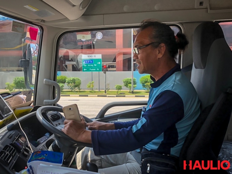 Uncle Foong smiling as he talks to his wife over the phone