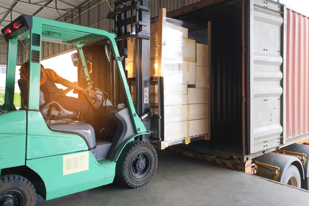 Forklift Driver Loading Cargo into Container